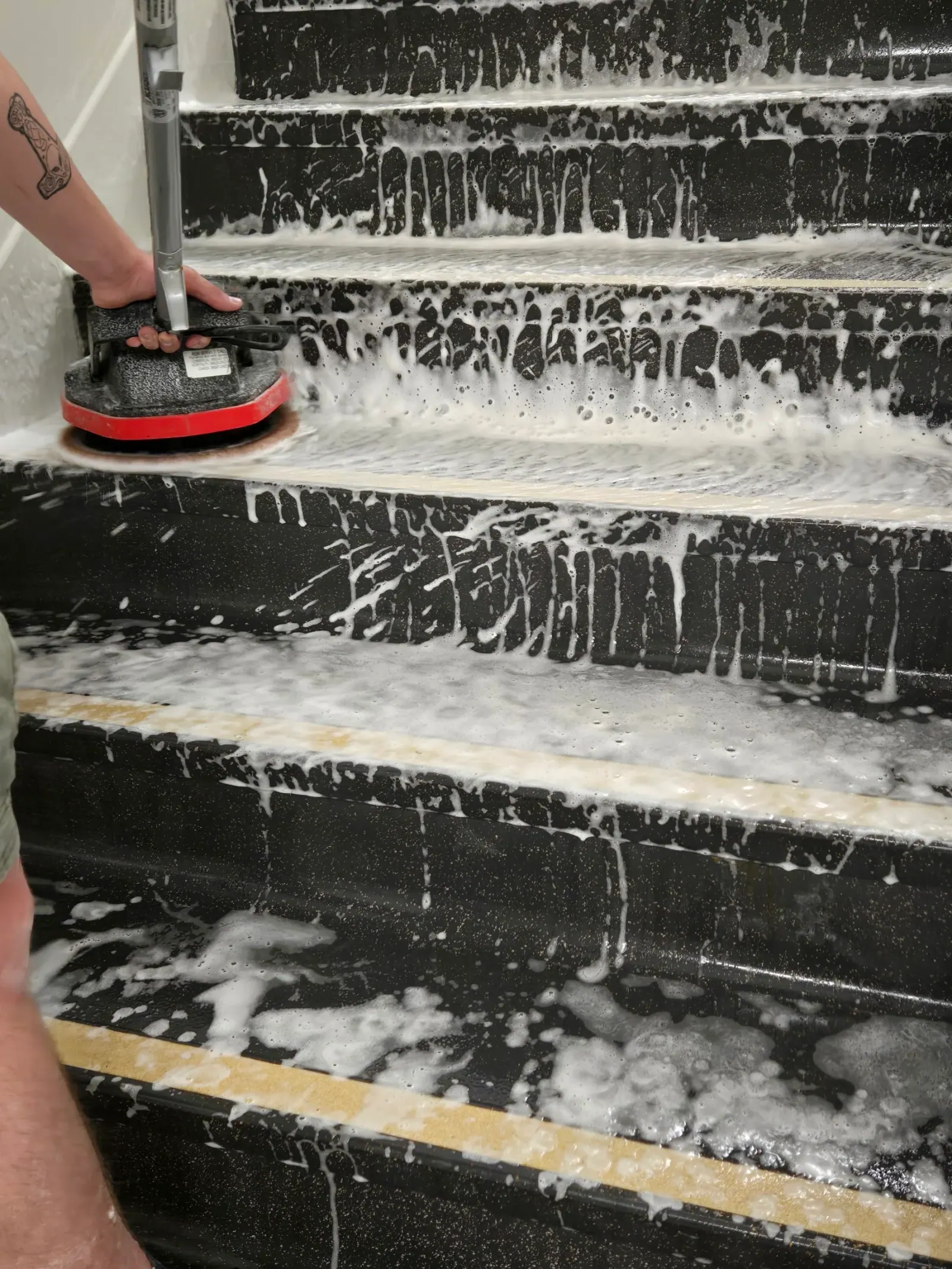 Stair treads covered in cleaning foam during work